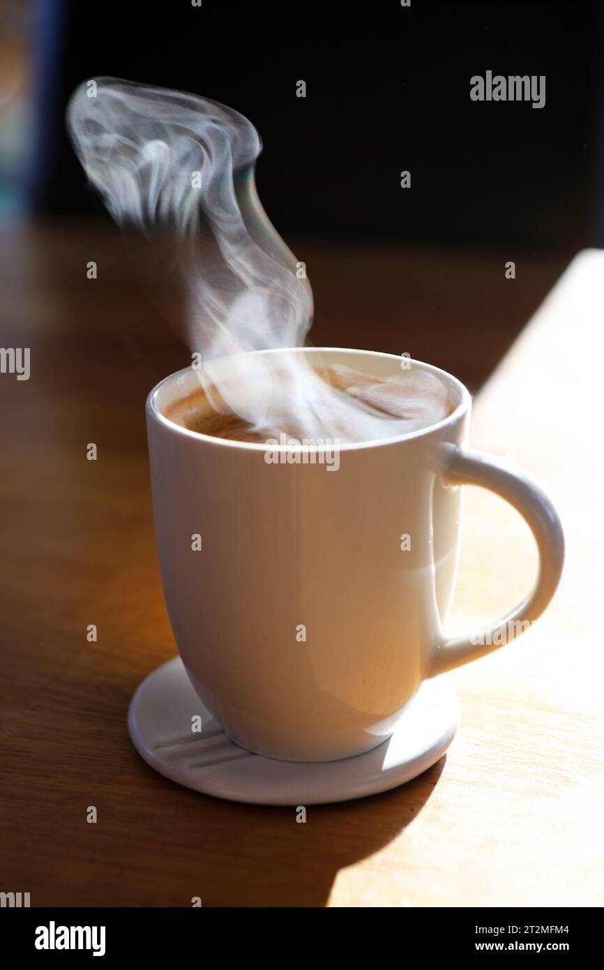 Steam rising off a mug of coffee on a cold day Stock Photo