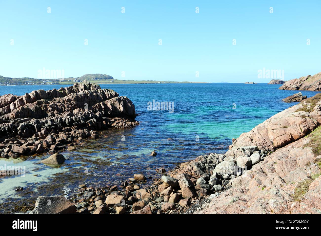View across the Sound of Iona to Iona from the rocky shoreline on the Isle of Mull Stock Photo