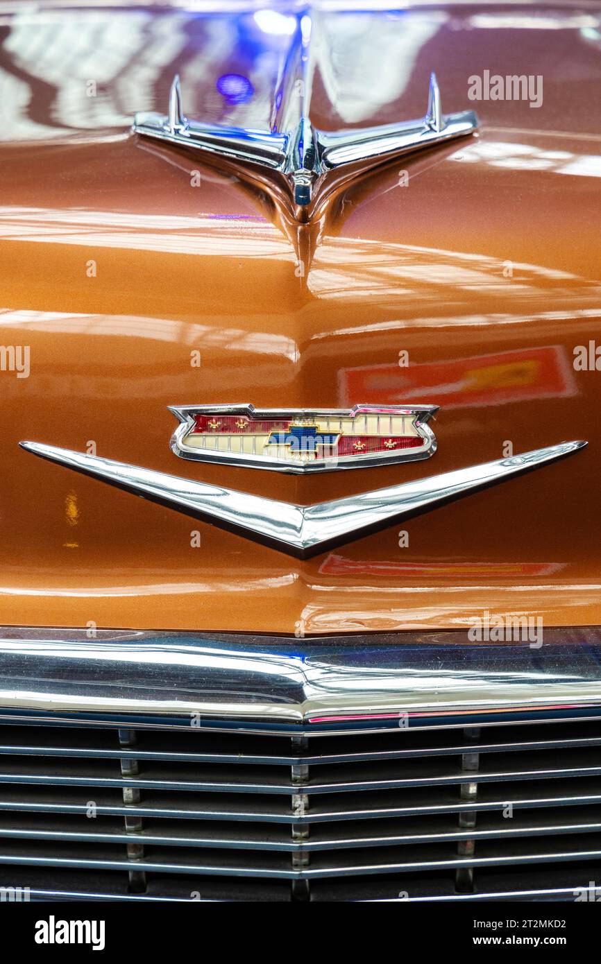 Logo and eagle bonnet mascot at the front of 1950s Chevrolet Bel Air, Autoworld museum, Brussels, Belgium Stock Photo