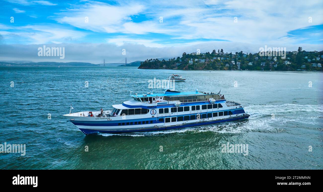 Golden Gate Ferry with smaller boat near Tiburon and Golden Gate Bridge in distance aerial Stock