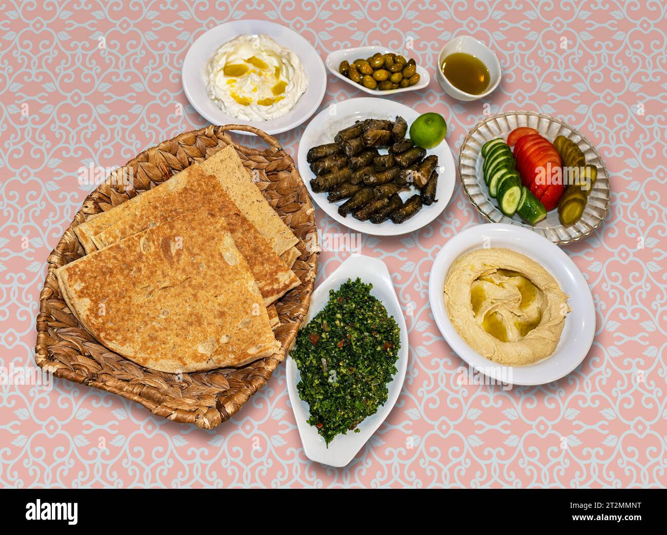 Kurdish meal of pita bread, stuffed grape leaves, salad, cucumber