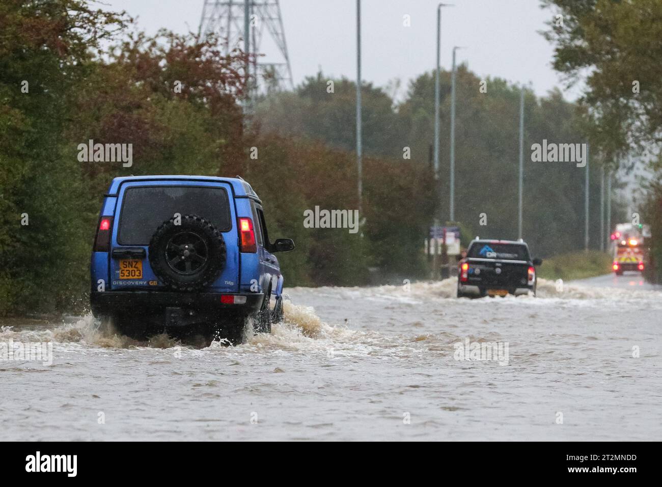 Allerton Bywater, UK. 20th Oct, 2023. Two vehicles brave the flooded