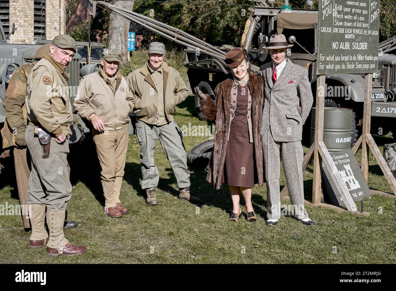 1940s people, English man and woman couple and USA army servicemen at a World War 2 re-enactment. England UK Stock Photo
