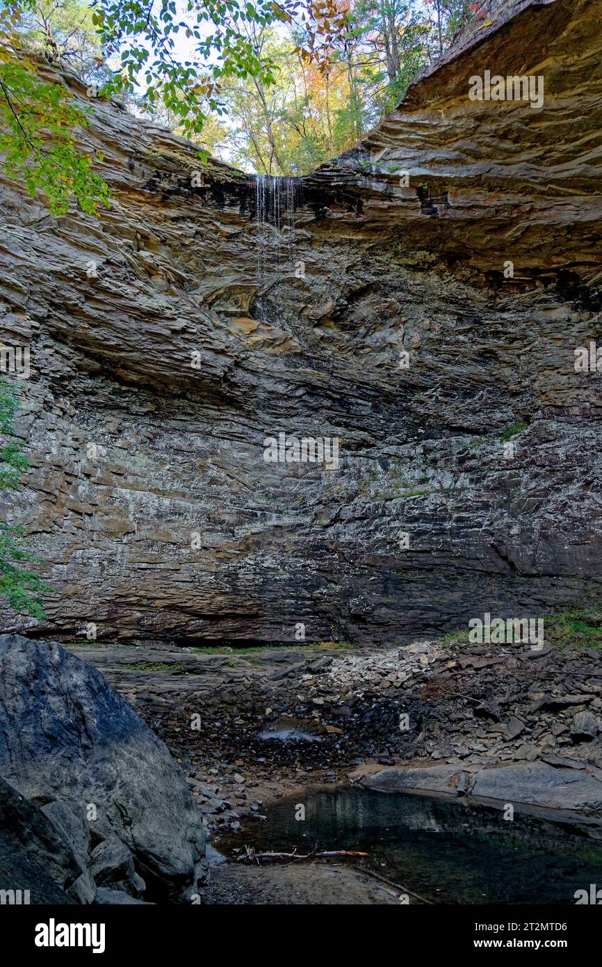 Very little water from no rain spilling over the cliff at Ozone falls with only a shallow pool of water on the bottom exposing the rocks in a drought Stock Photo