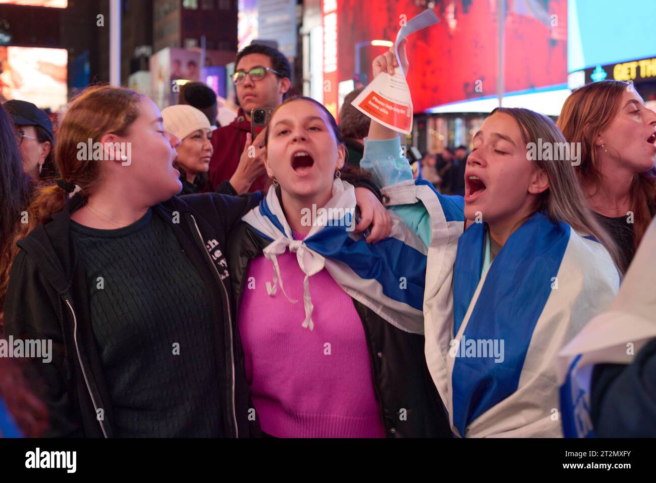 New York, New York, USA. 19th Oct, 2023. Young women embrace and sing ...