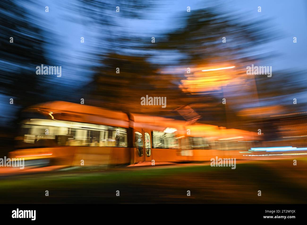 Dresden, Germany. 20th Oct, 2023. A streetcar of the Dresdner Verkehrsbetriebe (DVB) drives through the district Johannstadt in the evening. (shot with long exposure time) Credit: Robert Michael/dpa/Alamy Live News Stock Photo