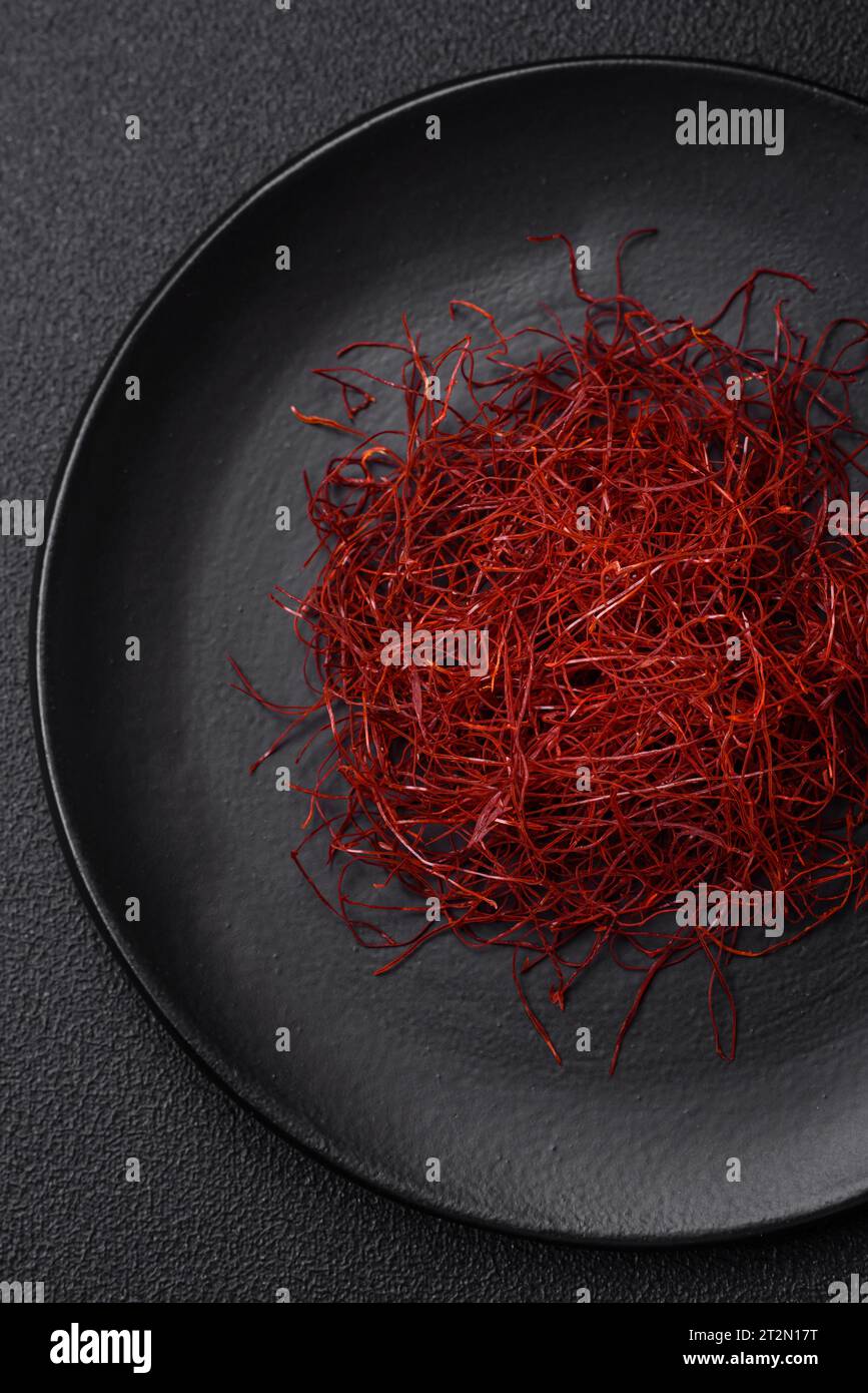 Red thin hot chili threads on a dark background. For decorating Asian ...