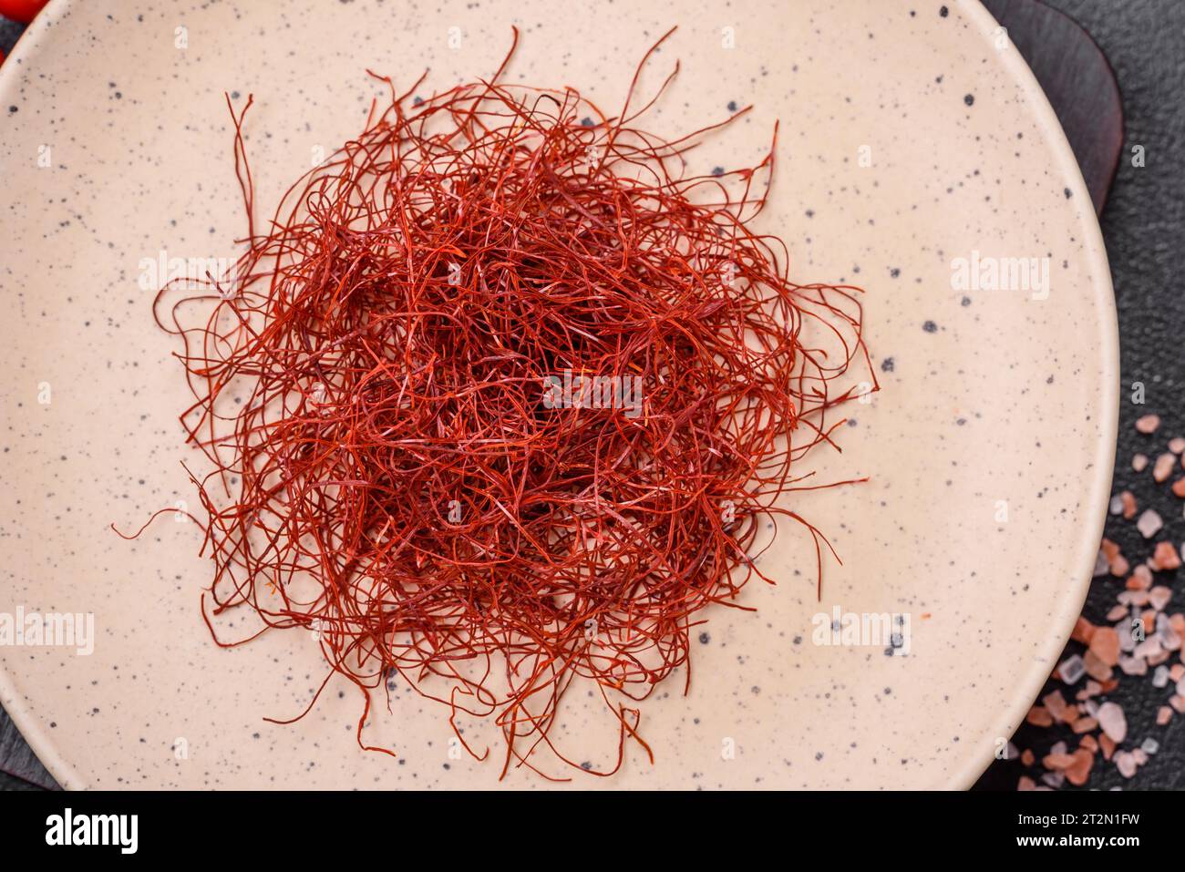 Red thin hot chili threads on a dark background. For decorating Asian ...