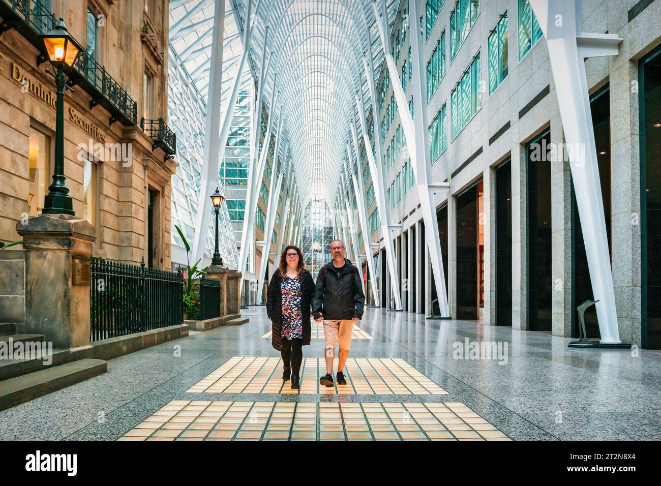 Adult couple walks in Brookfield Place in downtown Toronto, Ontario, Canada. Stock Photo