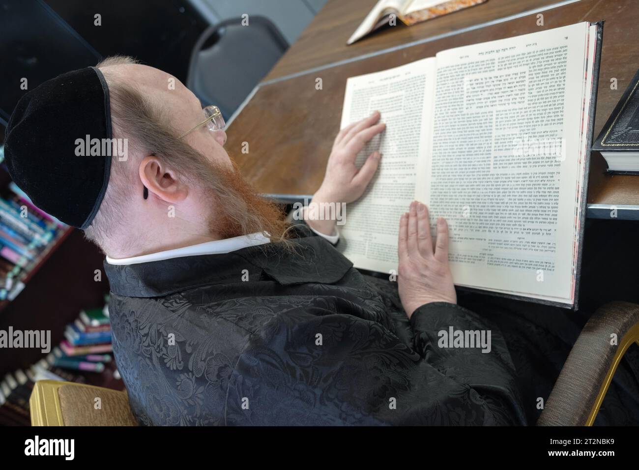 An orthodox rabbi reads from the Talmud in a class he is teaching adults in a synagogue in Rockland County, New York. Stock Photo