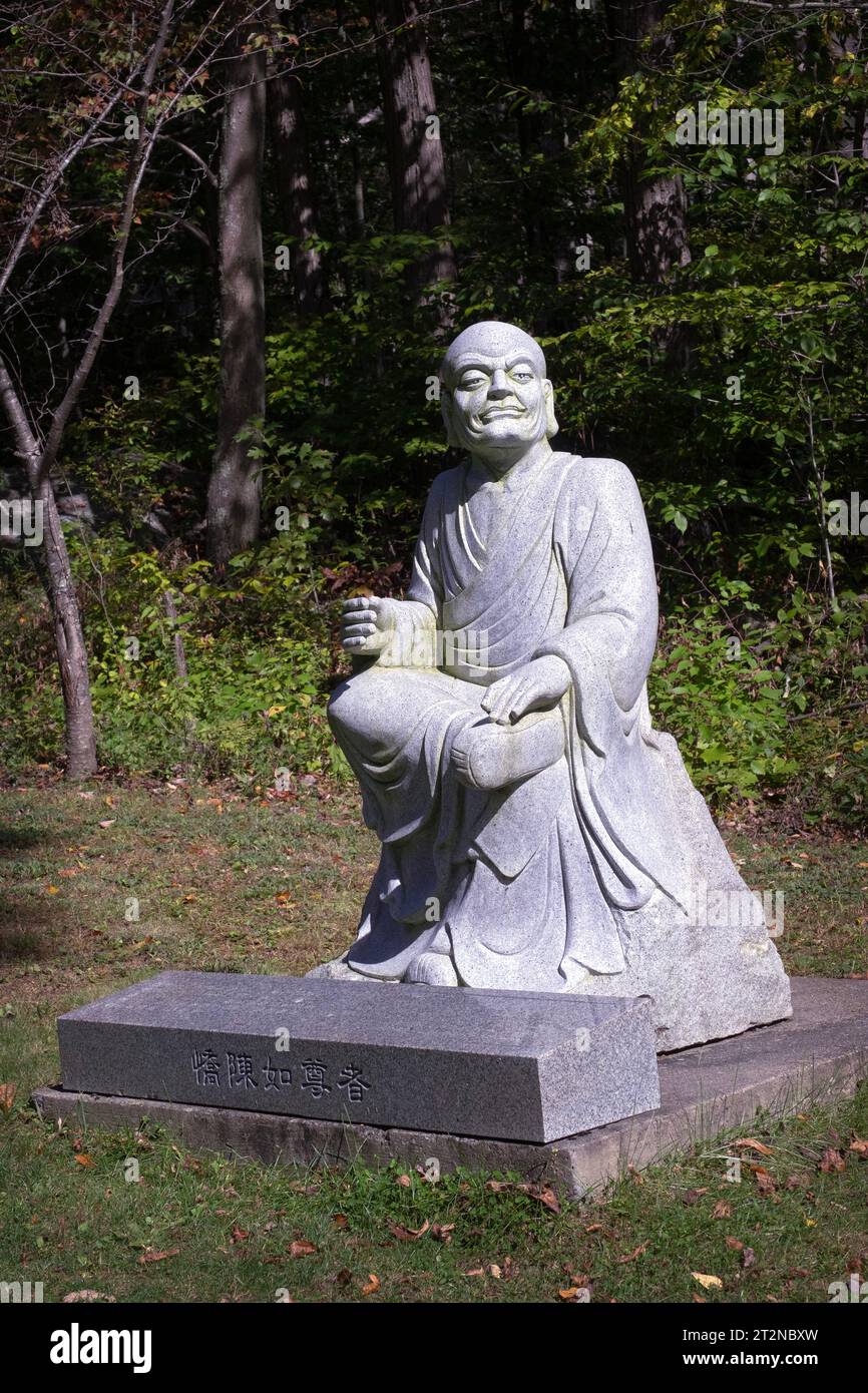 A statue of Kondanna Thera, a disciple of Buddha. On the path to the Chuang Yen Buddhist Monastery in Carmel, Putnam County, NY. Stock Photo