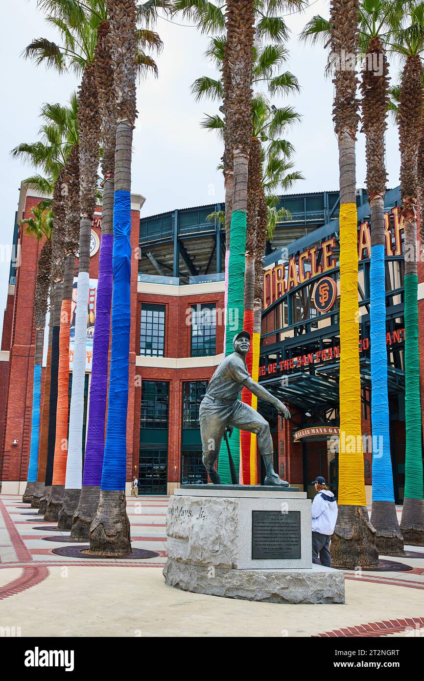 Willie Mays statue in front of Oracle Park entrance with colorful