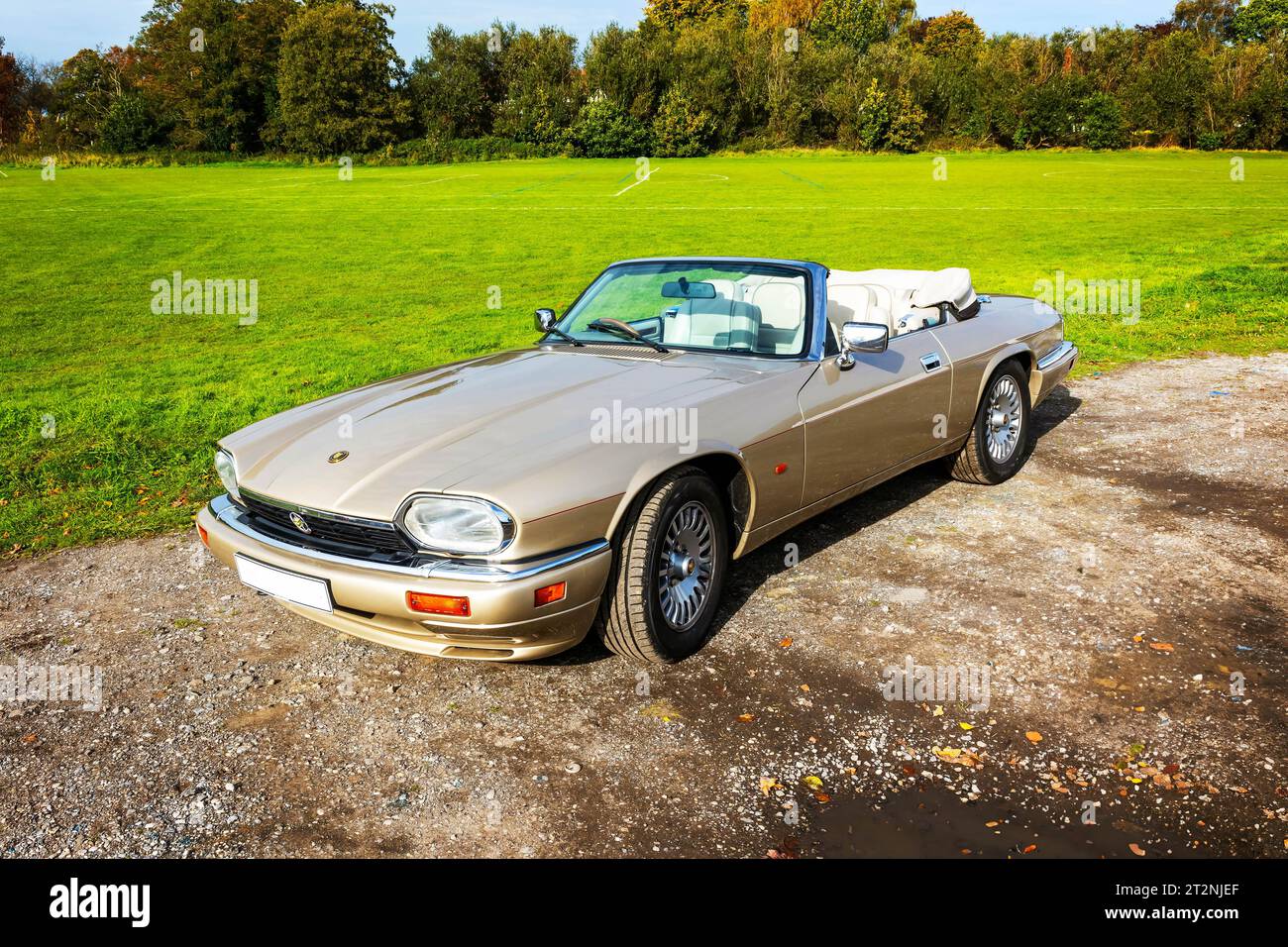 Convertible Jaguar XJS with top down on a gravel car park in the country Stock Photo