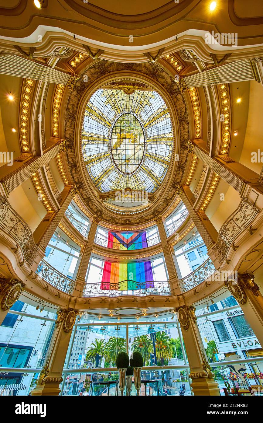 Upward view of stained glass ceiling with rainbow flag dangling outside ...