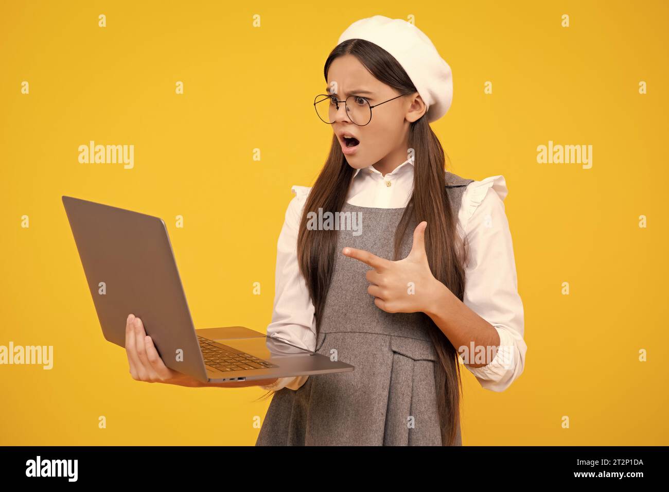 Back to school, Teenager school girl with laptop computer. Angry face ...