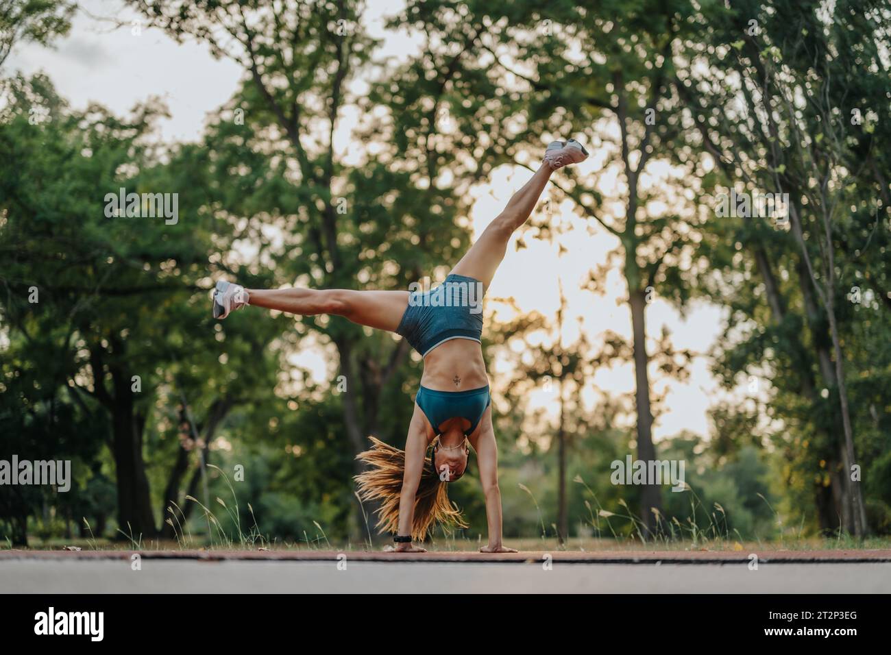 Fit and flexible athletic girl performing impressive 360 degree