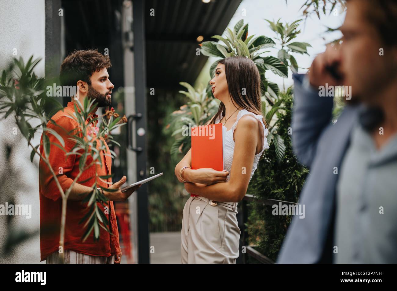 Innovative Architects Collaborating on Construction Project with Blueprint on Tablet Stock Photo