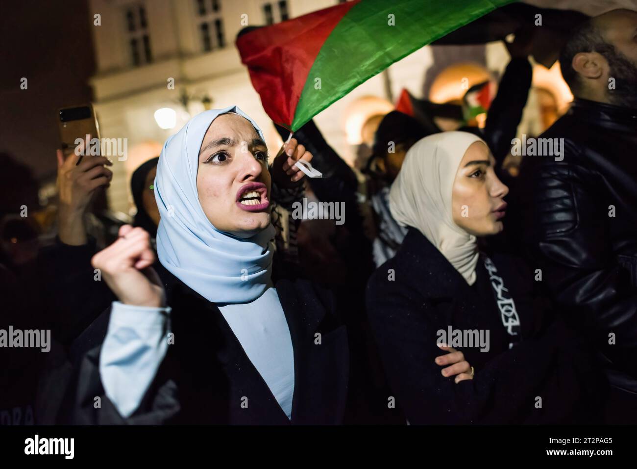 Protesters chant slogans during the pro-Palestinian rally in Warsaw. Hundreds of people - among them Palestinians - gathered in pouring rain in Warsaw's center to protest under the slogan 'Stop ethnic cleansing in Gaza'. The pro-Palestinian demonstrators demand end of bombing civilian targets in Gaza by Israel, open the humanitarian corridors and provide food, water and medicine to the inhabitants of the Gaza Strip. Protesters chanted slogans like 'Free Palestine' or 'Israel is a terrorist state'. (Photo by Attila Husejnow/SOPA Images/Sipa USA) Stock Photo