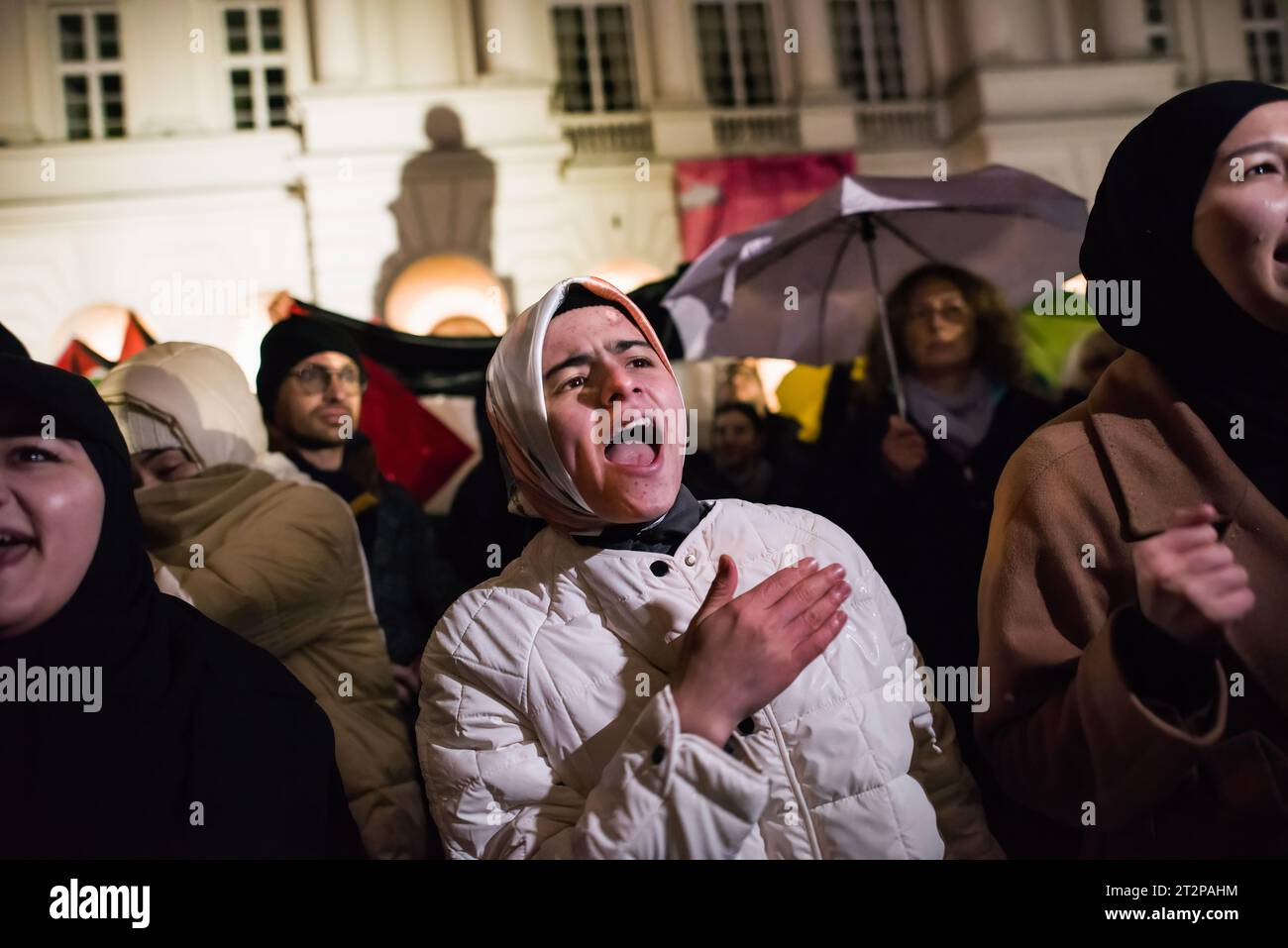 Protesters chant slogans during the pro-Palestinian rally in Warsaw. Hundreds of people - among them Palestinians - gathered in pouring rain in Warsaw's center to protest under the slogan 'Stop ethnic cleansing in Gaza'. The pro-Palestinian demonstrators demand end of bombing civilian targets in Gaza by Israel, open the humanitarian corridors and provide food, water and medicine to the inhabitants of the Gaza Strip. Protesters chanted slogans like 'Free Palestine' or 'Israel is a terrorist state'. (Photo by Attila Husejnow/SOPA Images/Sipa USA) Stock Photo