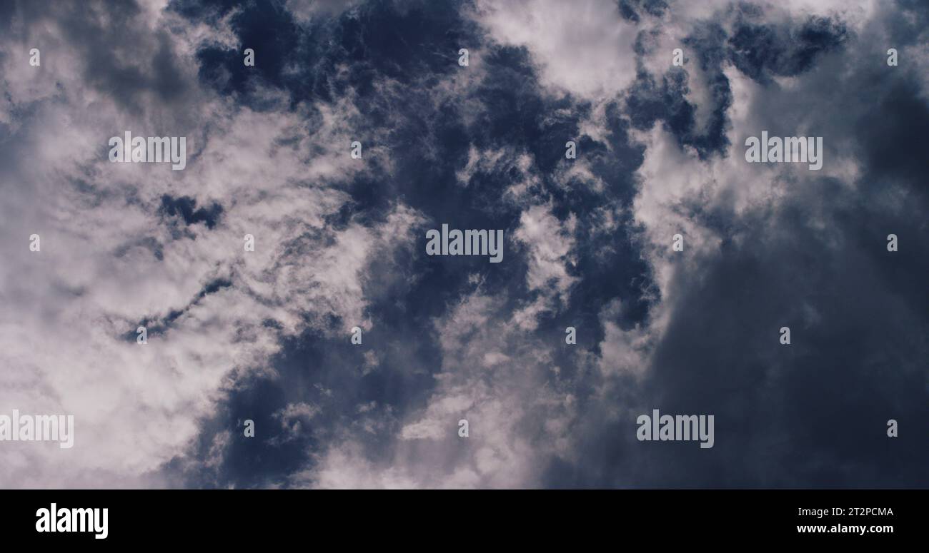 Delicately defined cirrus and cirrostratus clouds high above altocumulus clouds that create a beautiful and dreamy yet fleeting evening sky show. Stock Photo