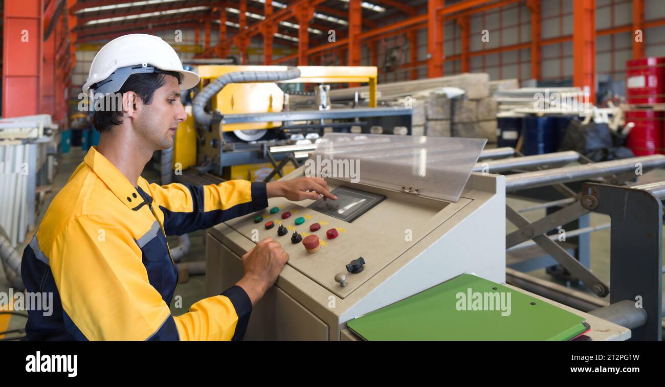 Industrious worker meticulously operating complex machinery within a bustling manufacturing plant. Stock Photo