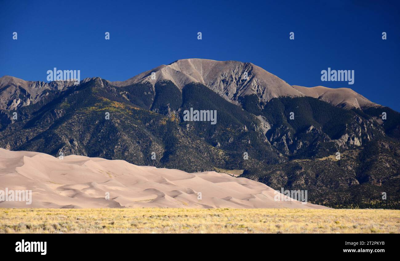 sand dunes and peaks of the  sangre de cristo  mountains on a sunny day in great  sand dunes national park, near alamosa, colorado Stock Photo