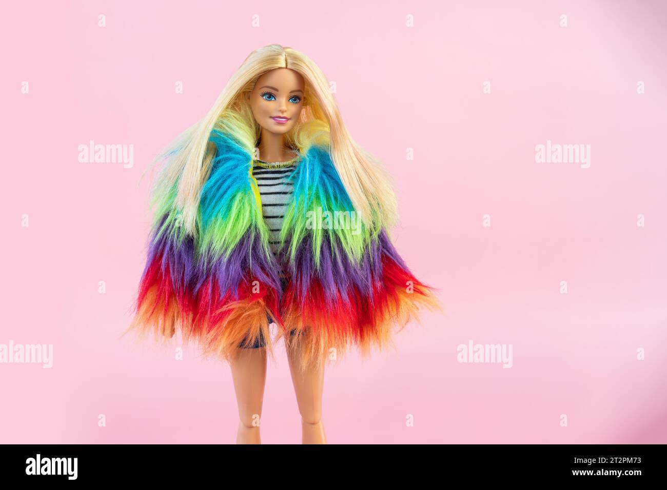 October 9, 2023. Barnaul, Russia: Barbie doll with loose blond hair standing on a pink background. Stock Photo