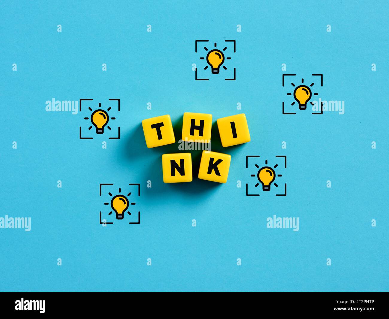 Thinking and generating creative ideas. Brainstorming in business or education. To find a solution. The word think on yellow cubes with light bulb ide Stock Photo