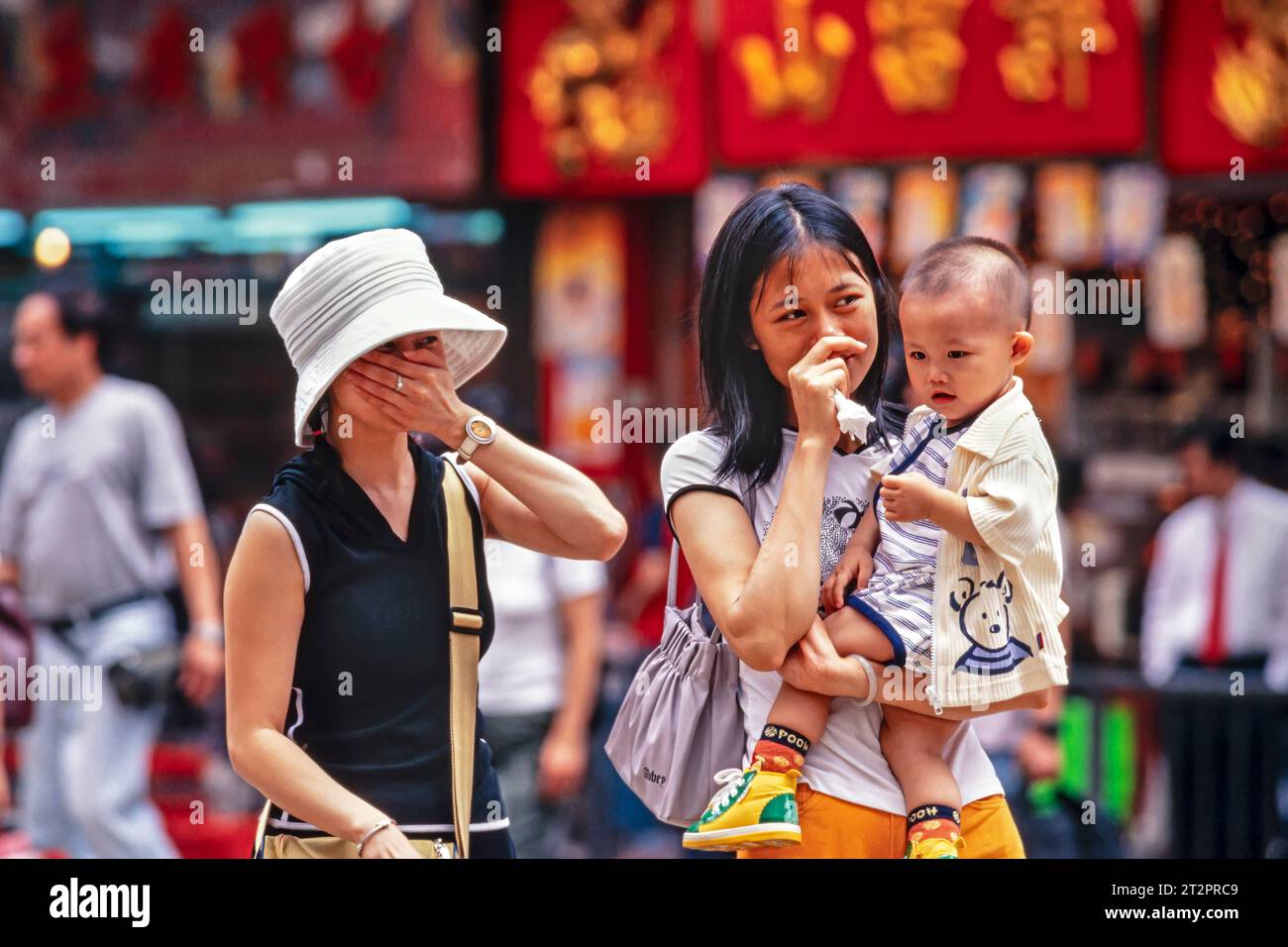 Pedestrians with breathing problems from air pollution, Wanchai, Hong Kong, SAR, China Stock Photo