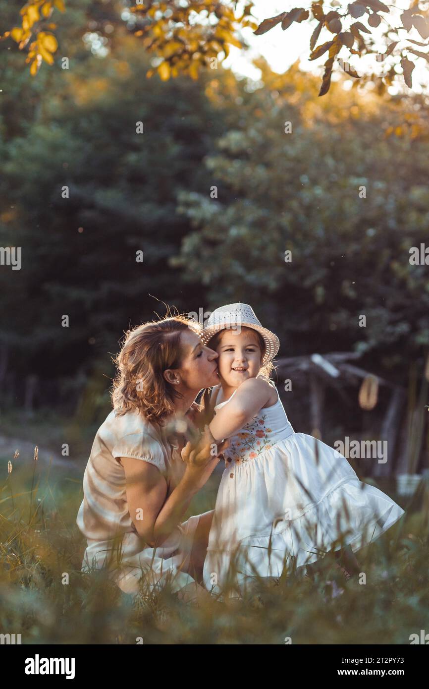 Mother and daughter enjoying a sunny weather in nature Stock Photo