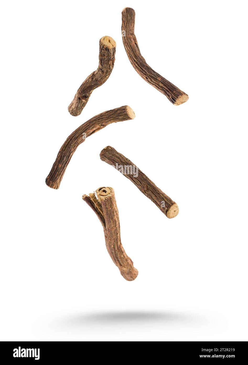 Sticks of liquorice root floating on white background. Stock Photo