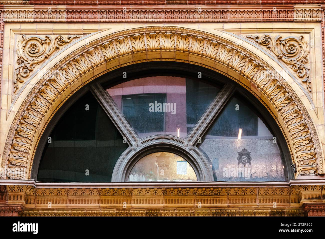 Toronto, Canada, Colonial style arch window and its decorations in the Hudson Bay building facade. Point of view from Yonge Street. Architectural feat Stock Photo