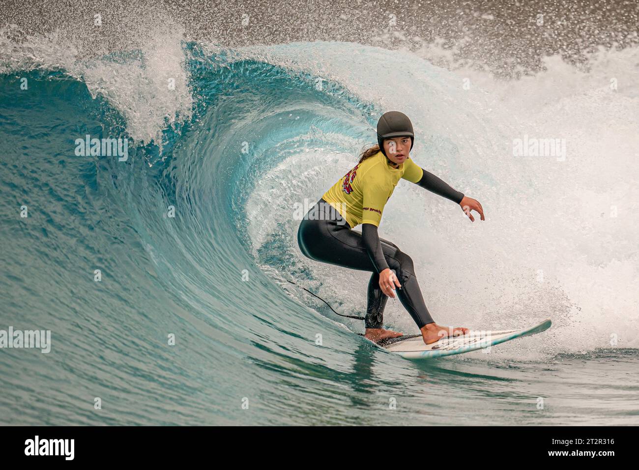 Luna Carerra 16 looks down the line of a clean wave as junior surfers
