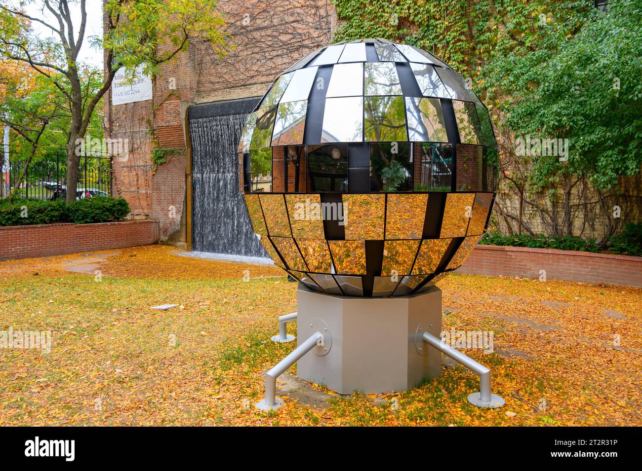 Toronto, Canada, work of art consisting on a sphere covered in pieces of mirrors. The object is located in the Toronto Sculpture Garden in 115 King St Stock Photo
