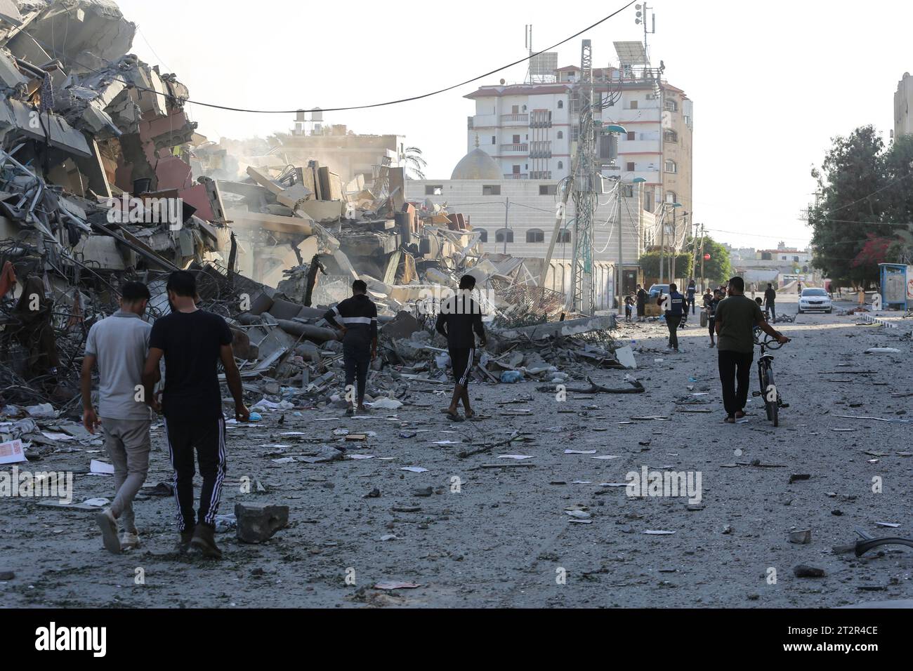 Palestinians inspect damages after Israeli strikes on the towers, of Al ...