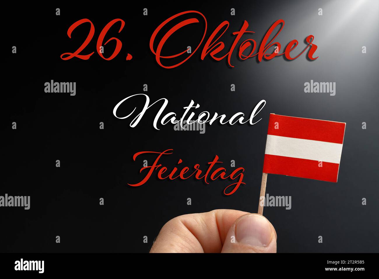 National holiday in, Austria. 21st Oct, 2023. on October 26 text above a hand holding an Austrian flag PHOTOMONTAGE *** Nationalfeiertag in Österreich am 26. Oktober Text über einer Hand die eine österreichische Flagge hält FOTOMONTAGE Credit: Imago/Alamy Live News Stock Photo