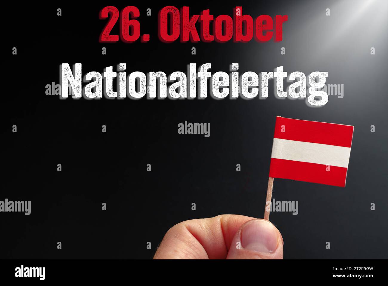 National holiday in, Austria. 21st Oct, 2023. on October 26 text above a hand holding an Austrian flag PHOTOMONTAGE *** Nationalfeiertag in Österreich am 26. Oktober Text über einer Hand die eine österreichische Flagge hält FOTOMONTAGE Credit: Imago/Alamy Live News Stock Photo
