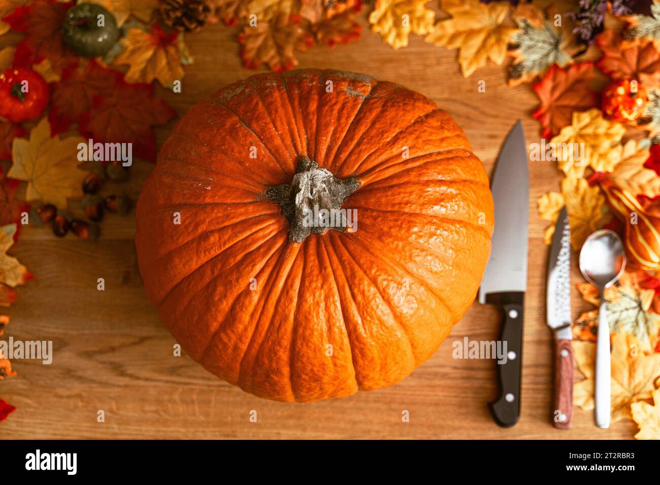 17 October 2023: Pumpkin on a table along with kitchen utensils to carve a Halloween pumpkin. Several knives and spoons are ready *** Kürbis auf einem Tisch zusammen mit Küchenutensilien um einen Halloween Kürbis zu Schnitzen. Mehrere Messer und Löffel liegen bereit Credit: Imago/Alamy Live News Stock Photo