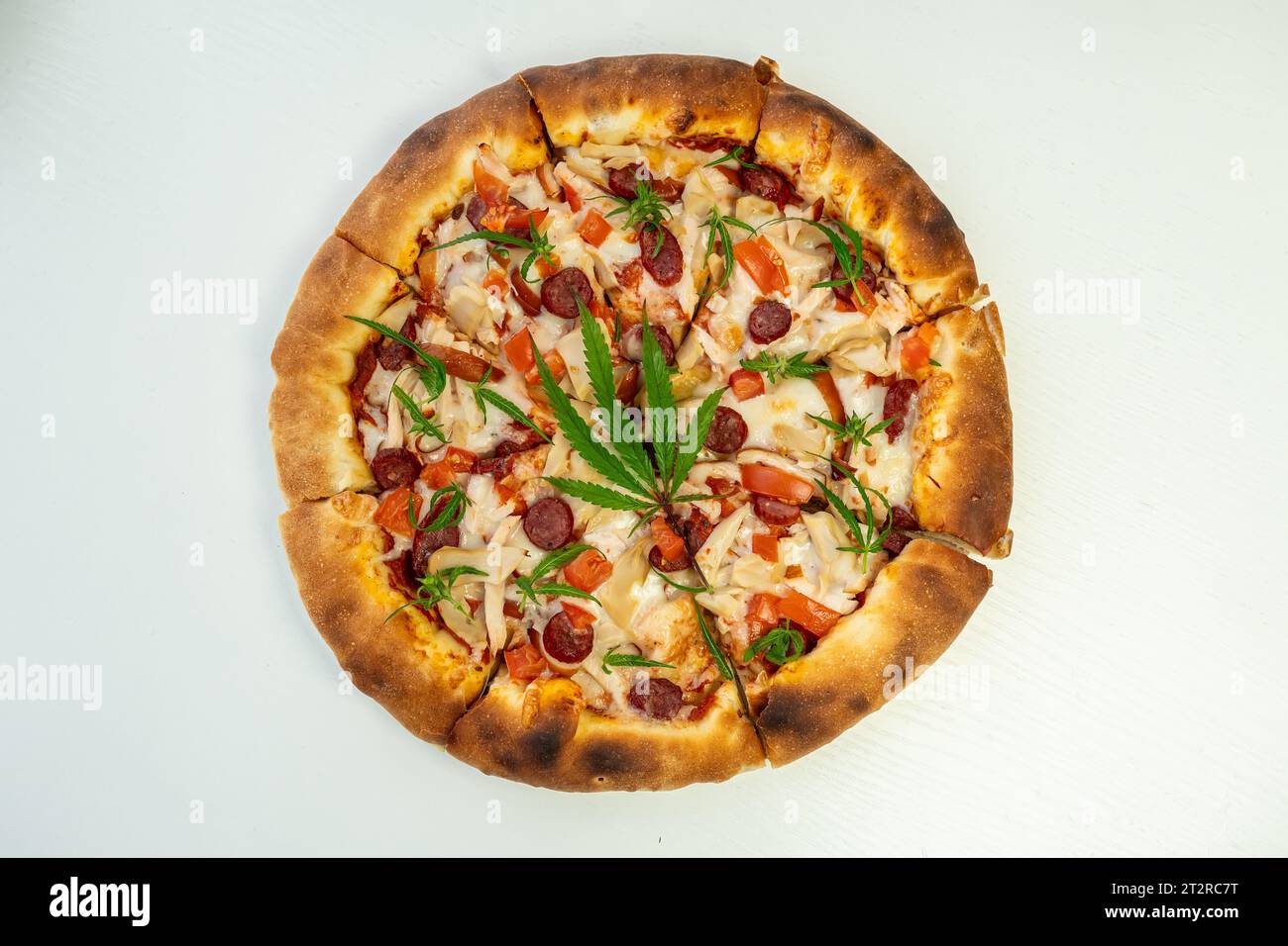 Homemade pizza with marijuana cannabis leaves. Fresh medical marijuana, cannabis decorate on pizza. close-up, macro, Stock Photo
