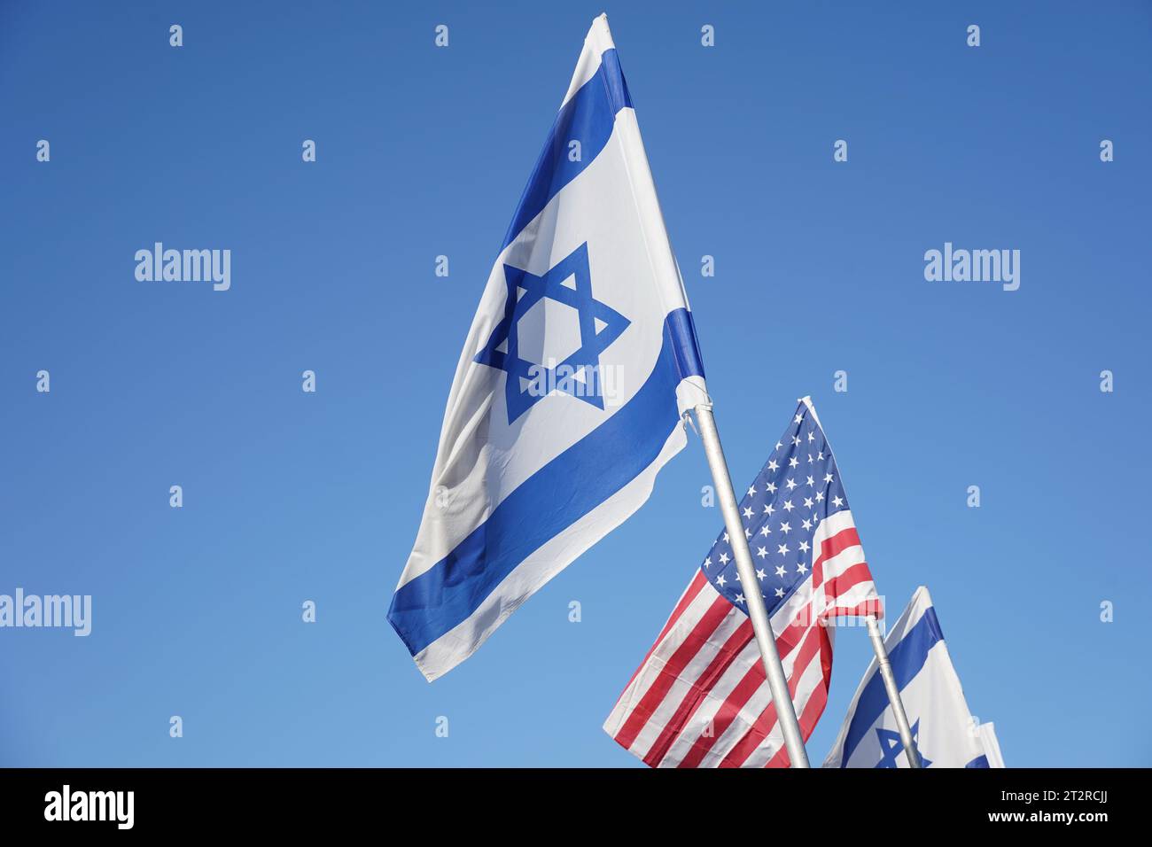Flags of the USA and Israel against the background of the blue sky ...