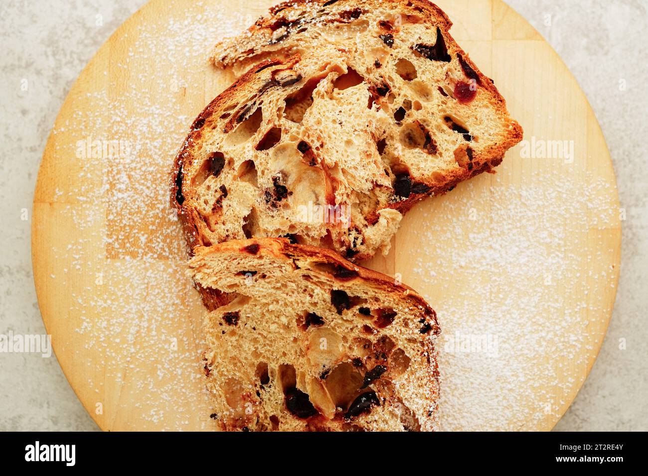 Cut panettone  on wooden board, Italian traditional Christmas cake Stock Photo
