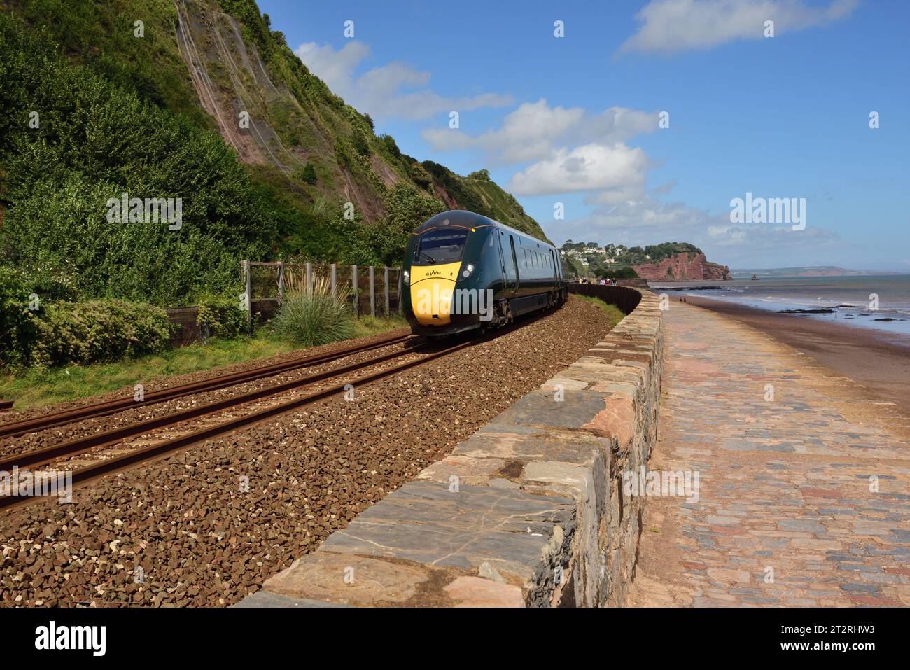 BR Class 800 IET No 800304 runs along the seawall at Teignmouth with a westbound train, looking towards Hole Head at Holcombe. Stock Photo