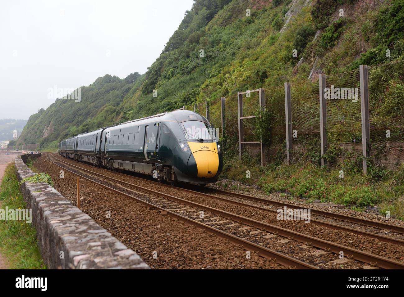 BR Class 802 Intercity Express Train No 802019 runs alongside the seawall at Teignmouth with 2U16 the 0847 Penzance to Cardiff. Stock Photo
