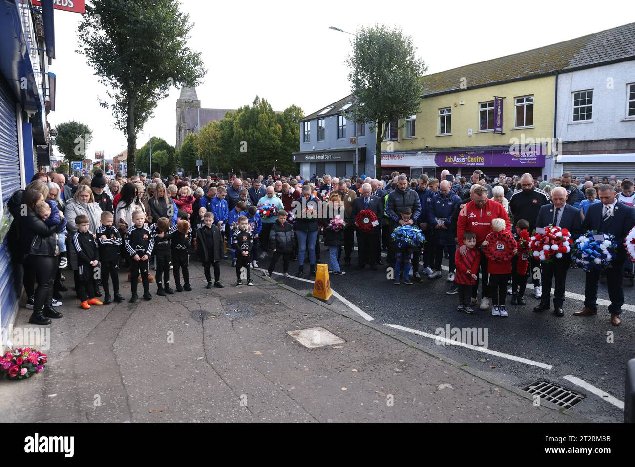 Members of the community take part in a minute's silence on Shankill