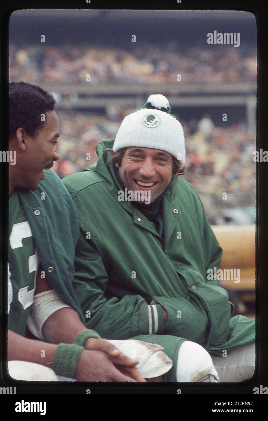 Joe Namath and end Jerome Barkum share a laugh on the bench during a New York Jets game at Shea Stadium in Flushing, Queens, New York. In 1976. Stock Photo