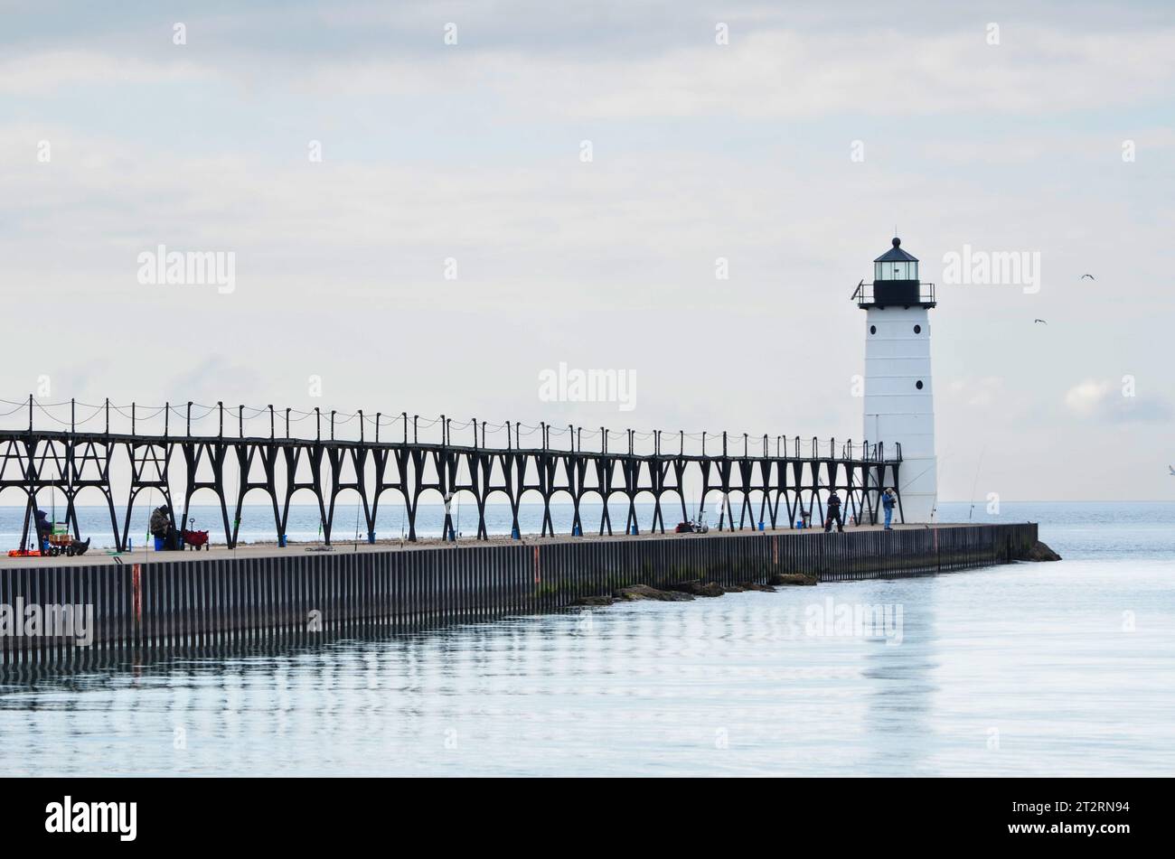Lighthouse at the end of a pier Stock Photo