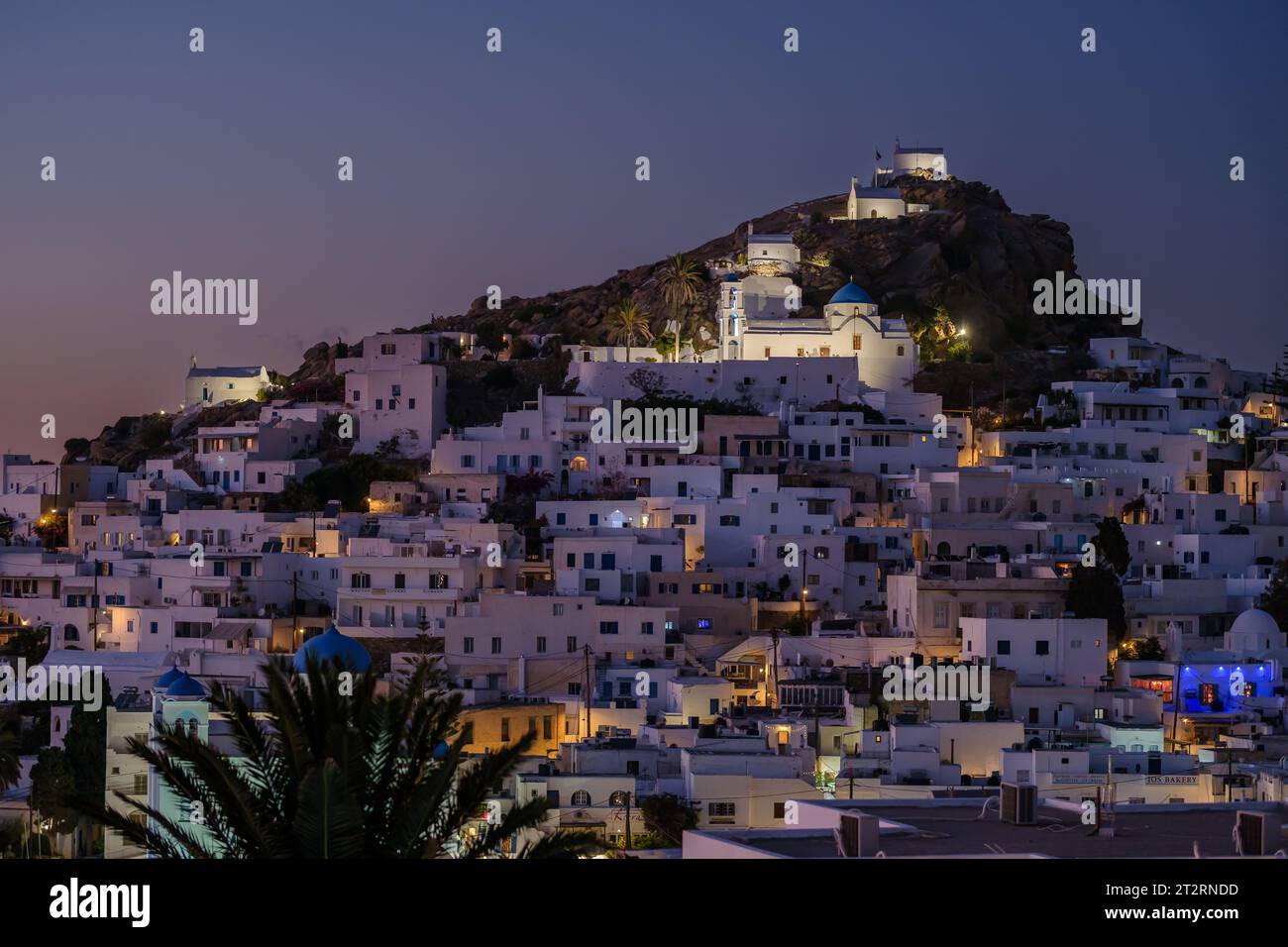 Ios, Greece - September 12, 2023 : Panoramic view of the picturesque illuminated island of Ios in Greece at sunset Stock Photo