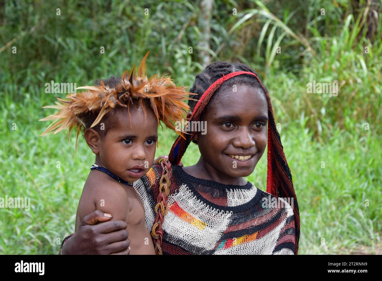 Women of the Dani Tribe with her child Stock Photo