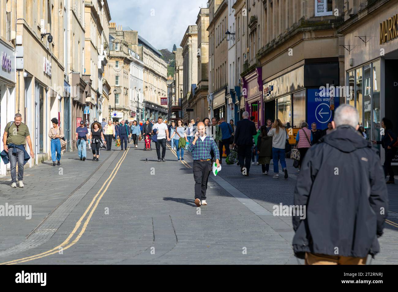 Shoppers walking in pedestrianised street in city centre, Stall Street, Bath, Somerset, England, UK Stock Photo