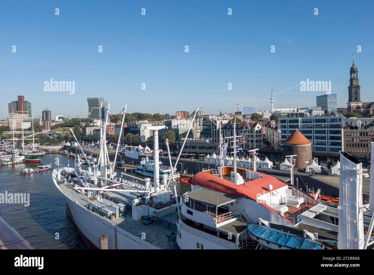 View of the Landungsbruecken and the museum ship Cap San Diego at the Ueberseebruecke in the Port of Hamburg from a cruise ship Stock Photo